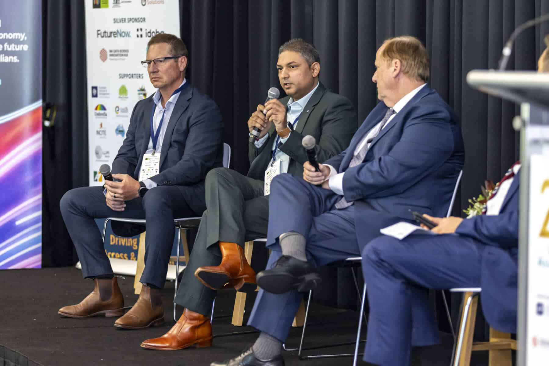 Nilesh Speaking during the Ministerial Panel. Sitting to his left is Hon Don Punch, and to his right is Greg Italiano